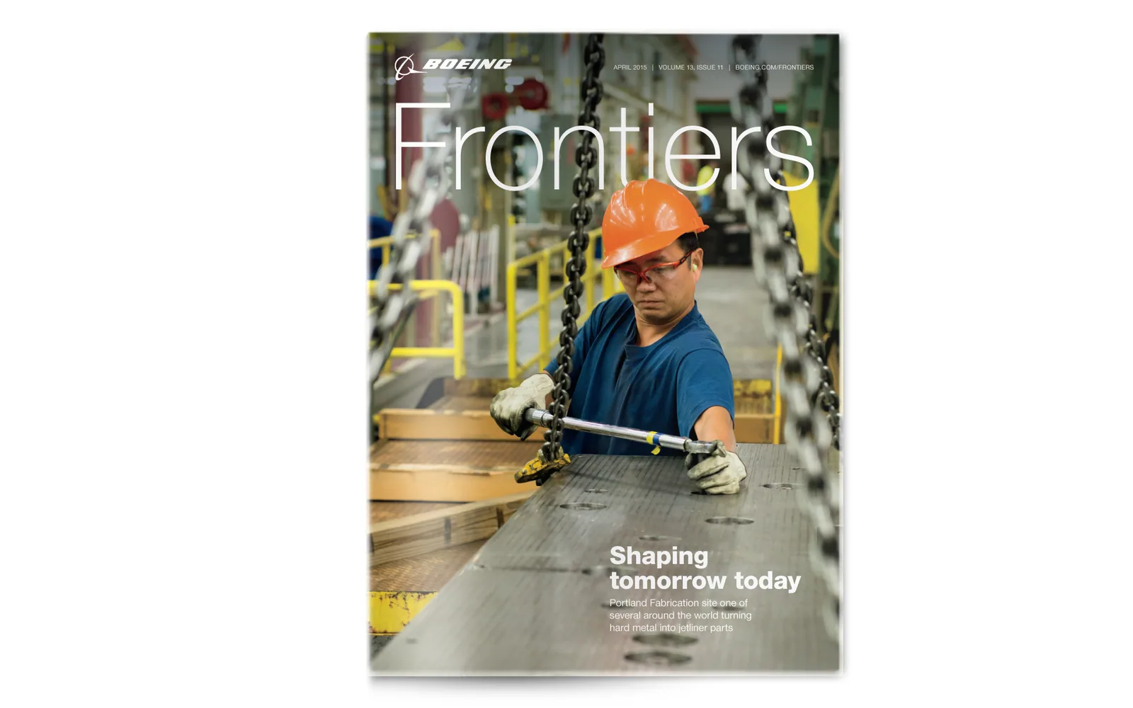 A Frontiers cover, Shaping tomorrow today: an employee in a hard hat working a chain hoist on the factory floor