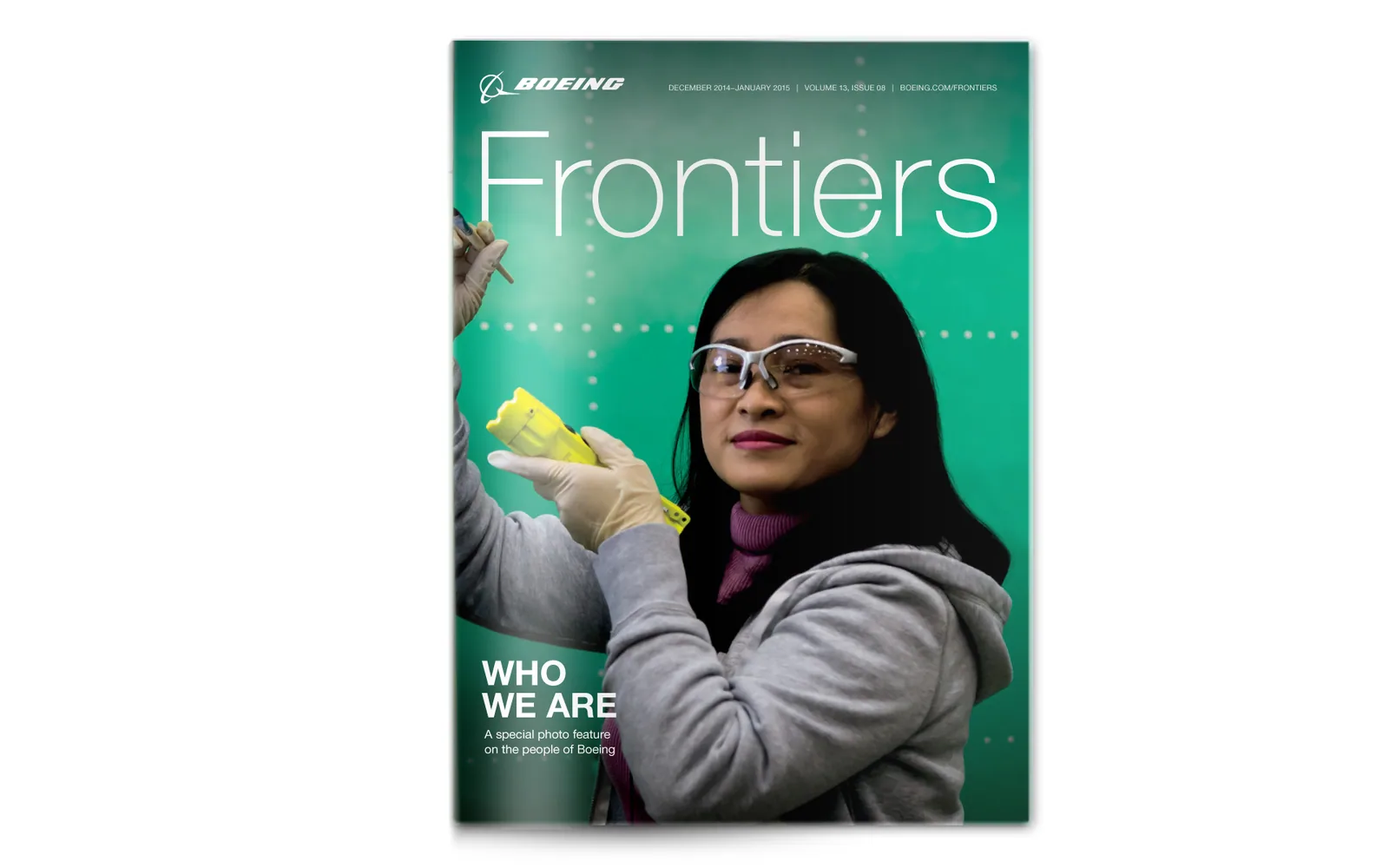 A Frontiers cover, Who we are: an employee in safety glasses holding a part