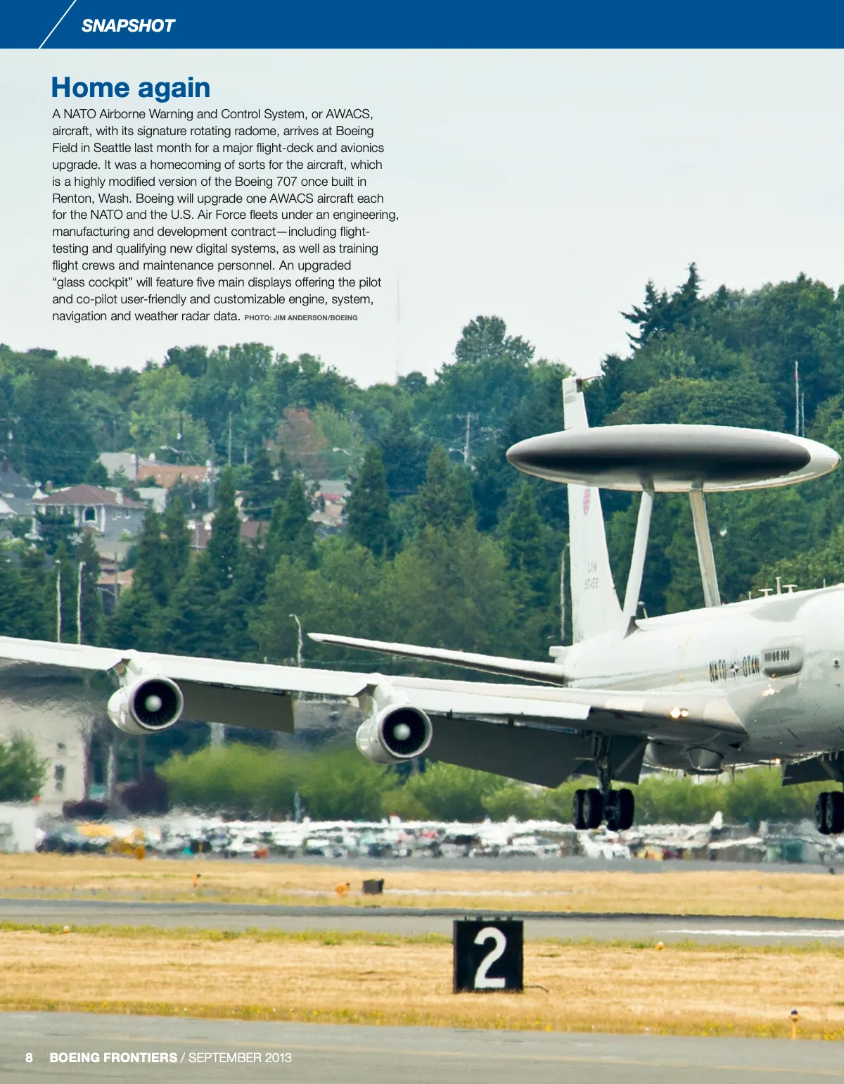 The September 2013 Snapshot page: a blue bar, a text block over a photo of an airborne early warning aircraft